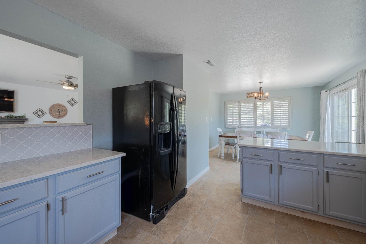 143 Tucker Road Watsonville, CA 95076 - Photo 16 of 42 a kitchen with a refrigerator and cabinets