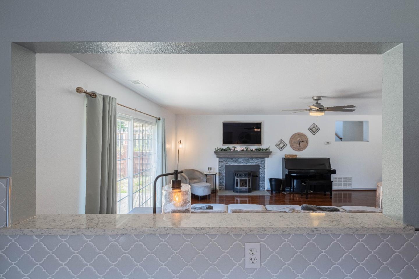 143 Tucker Road Watsonville, CA 95076 - Photo 17 of 42 a living room with furniture a fireplace and a flat tv screen