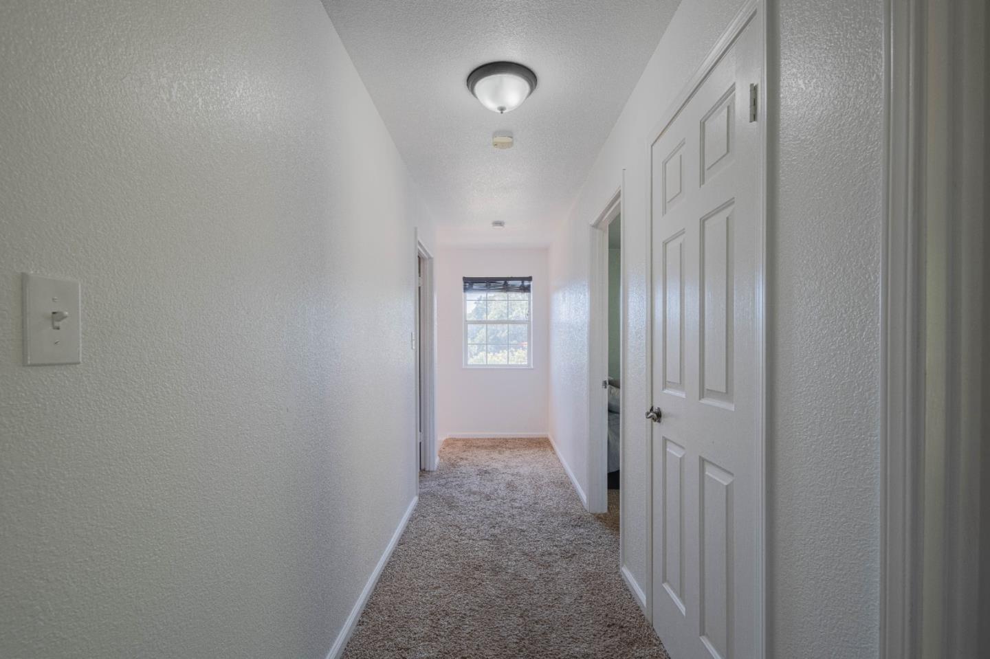 143 Tucker Road Watsonville, CA 95076 - Photo 20 of 42 a view of a hallway with wooden floor and closet