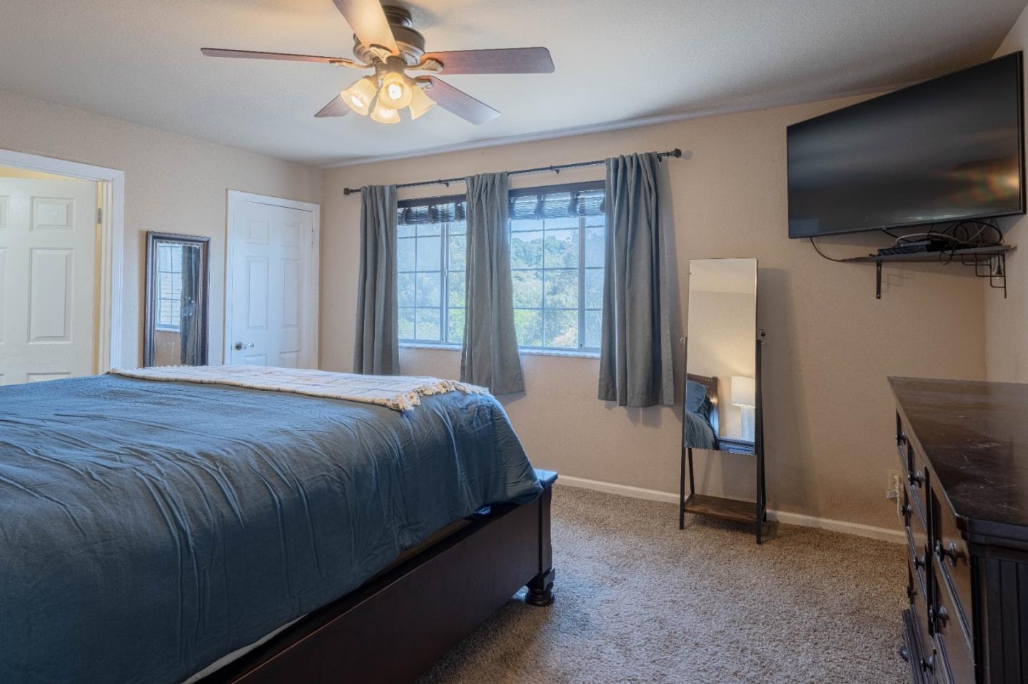 143 Tucker Road Watsonville, CA 95076 - Photo 21 of 42 a bed sitting in a spacious bedroom next to a window