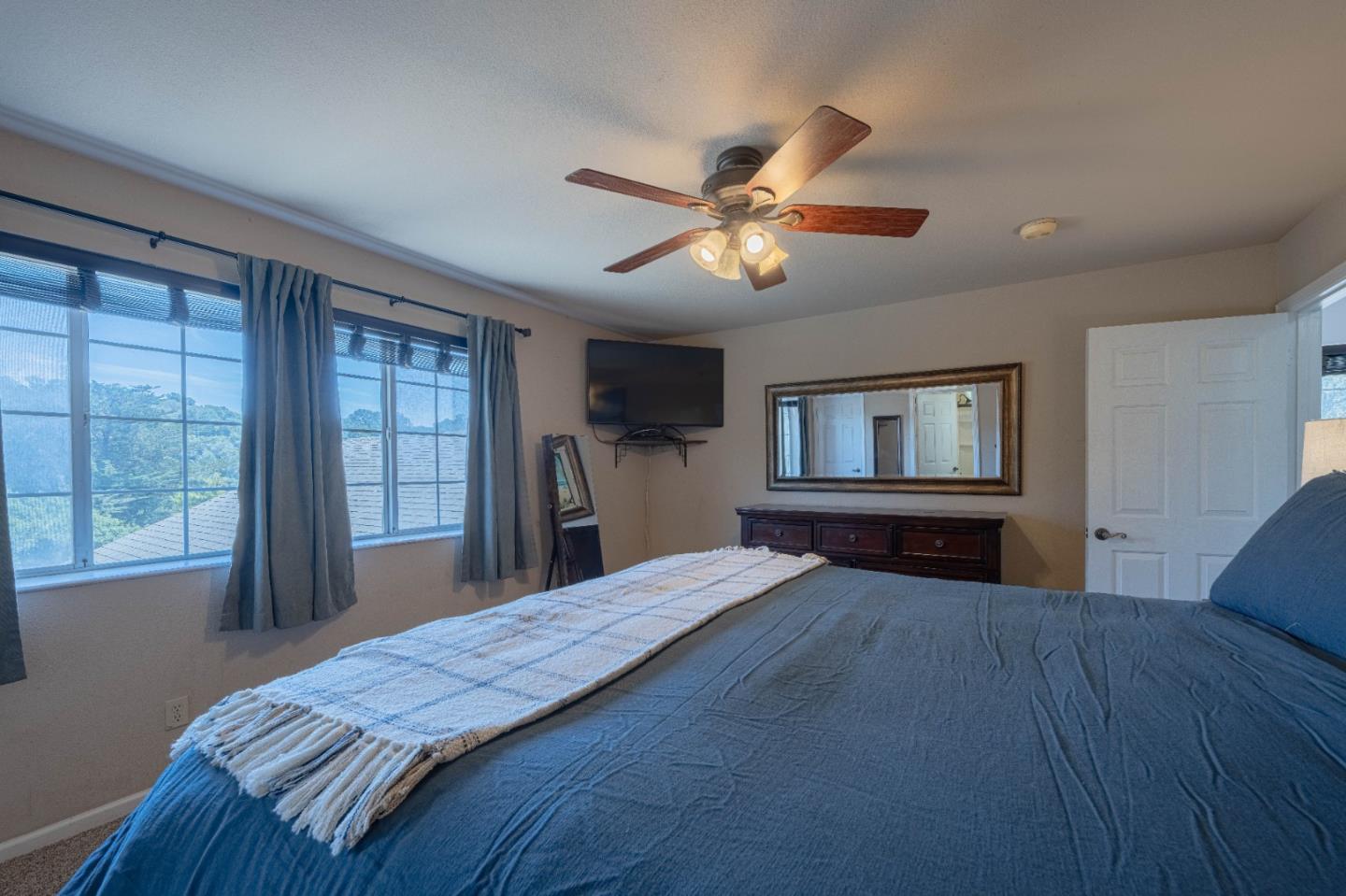 143 Tucker Road Watsonville, CA 95076 - Photo 23 of 42 a bedroom with a large bed chandelier and a window