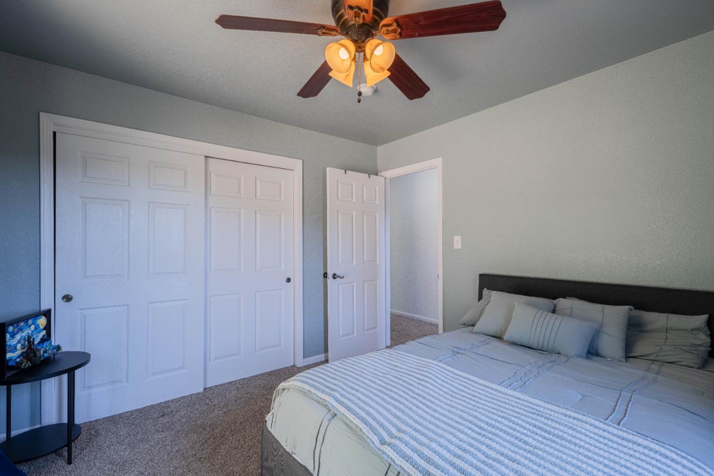 143 Tucker Road Watsonville, CA 95076 - Photo 28 of 42 a bedroom with a bed and a chandelier