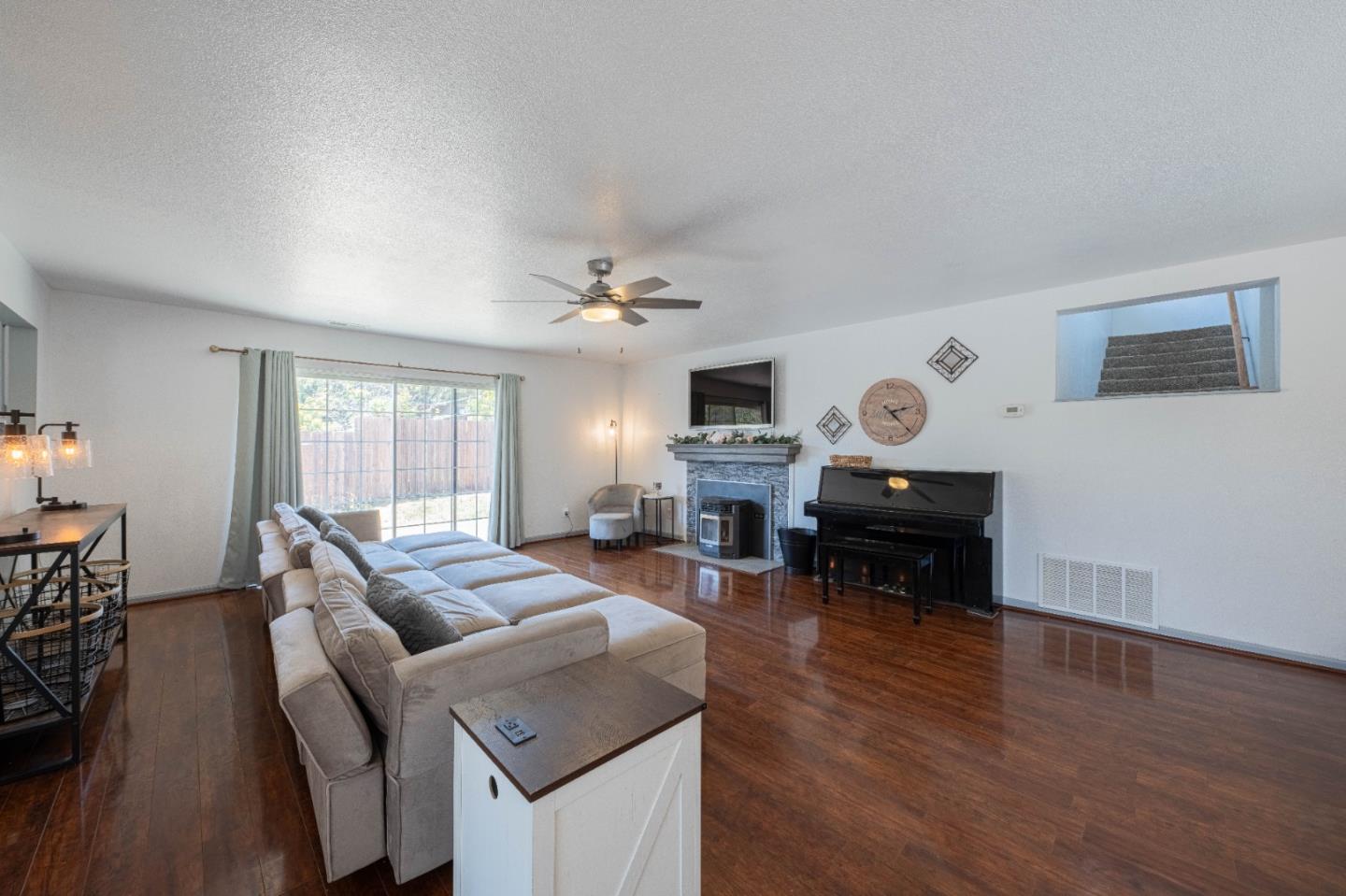 143 Tucker Road Watsonville, CA 95076 - Photo 4 of 42 a living room with fireplace furniture and a wooden floor