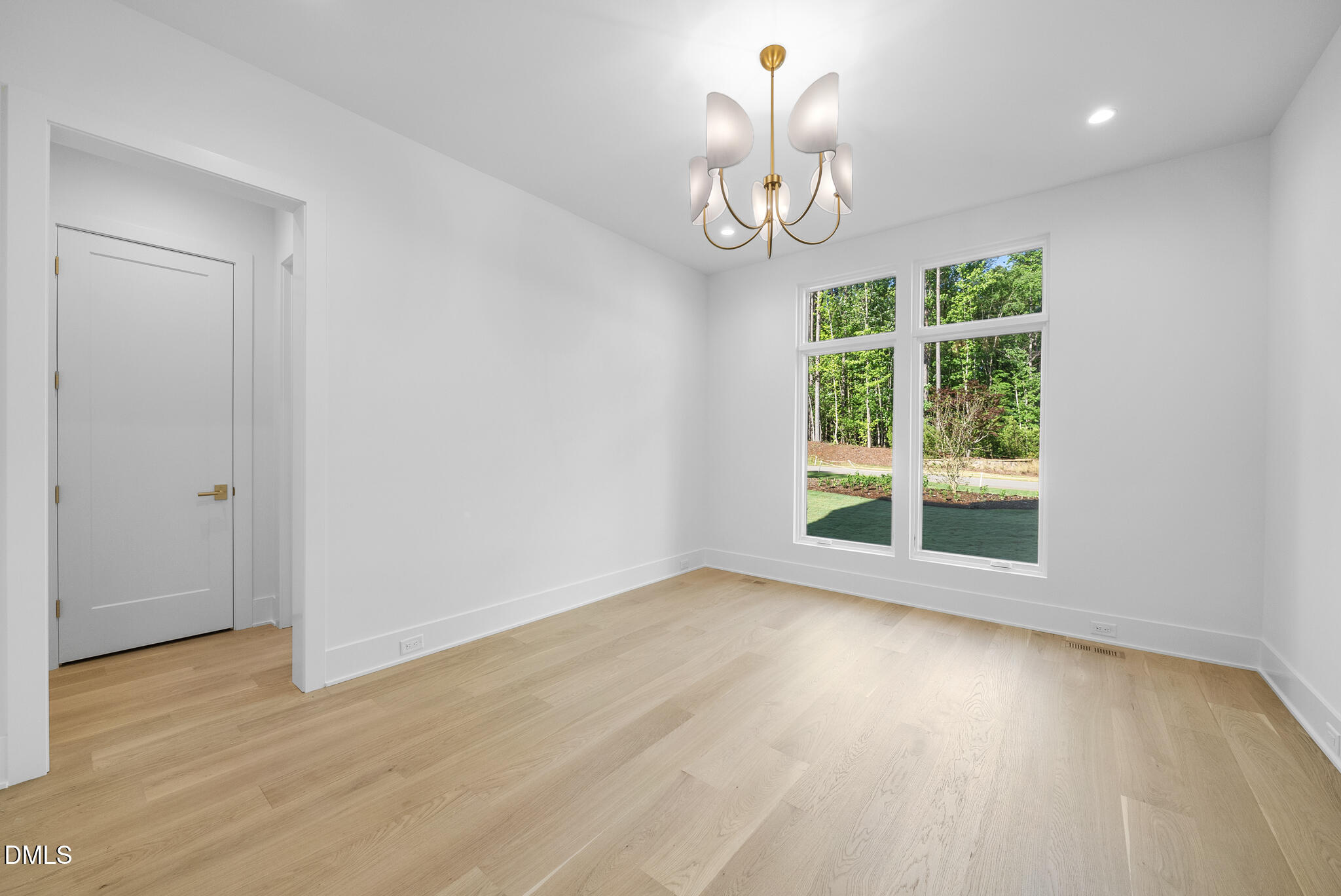 7608 Falls Creek Lane Raleigh, NC 27614 - Photo 61 of 74 a view of an empty room with wooden floor and a window