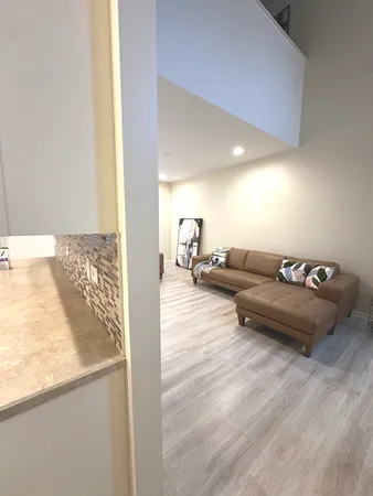 a kitchen with granite countertop a stove a sink and a microwave