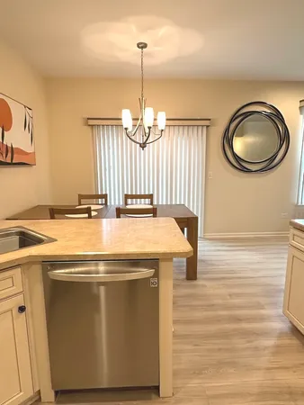 a view of a dining room with a table and chairs
