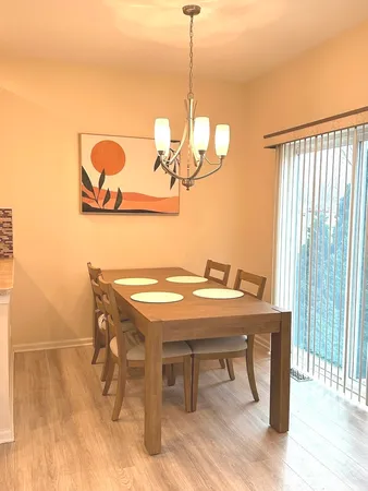 a large kitchen with stainless steel appliances granite countertop a stove a sink and a microwave