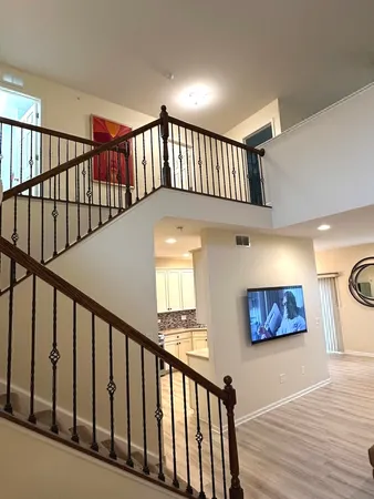 a bedroom with two beds and a chandelier
