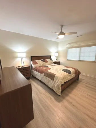 a view of a hallway with bedroom and wooden floor