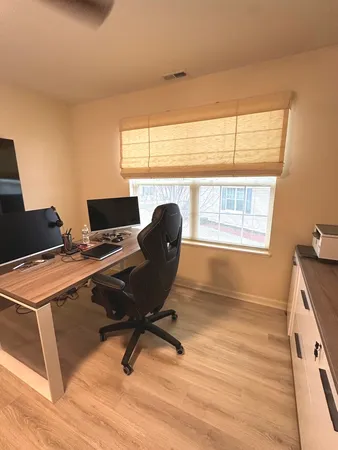 a view of empty room with wooden floor
