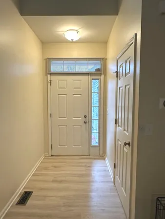 a view of a hallway with wooden floor