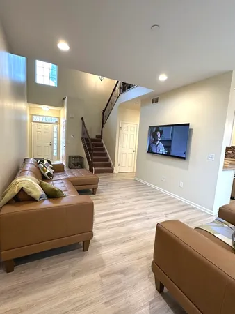a bedroom with furniture and a wooden floor