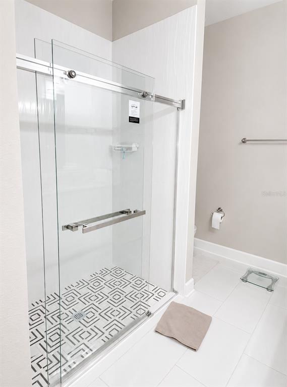 3834 Charter Road Lakeland, FL 33810 - Photo 20 of 39 a bathroom with a shower and a glass shower
