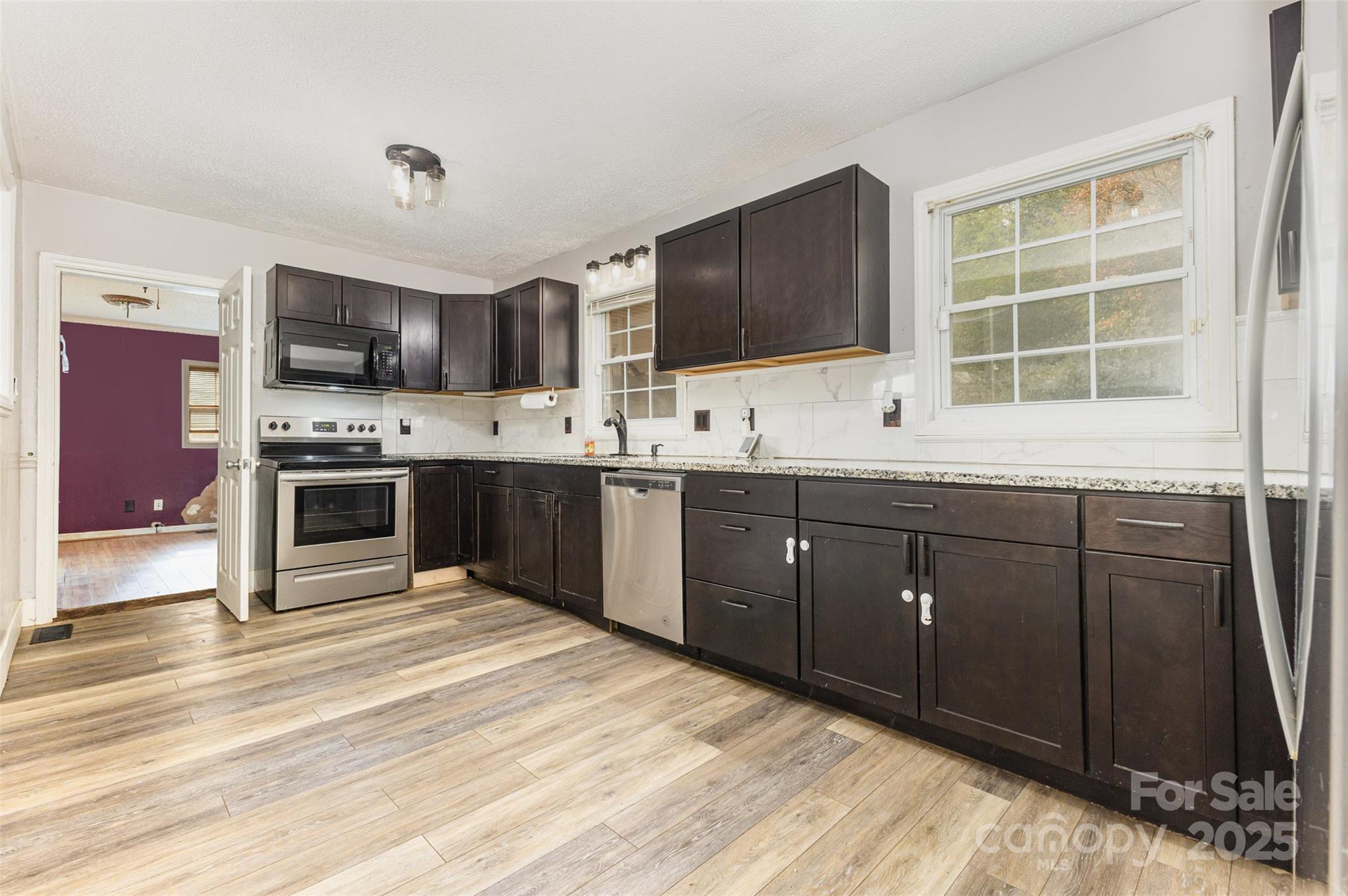 281 South Sutton Road Fort Mill, SC 29708 - Photo 6 of 21 a kitchen with stainless steel appliances granite countertop a sink and cabinets