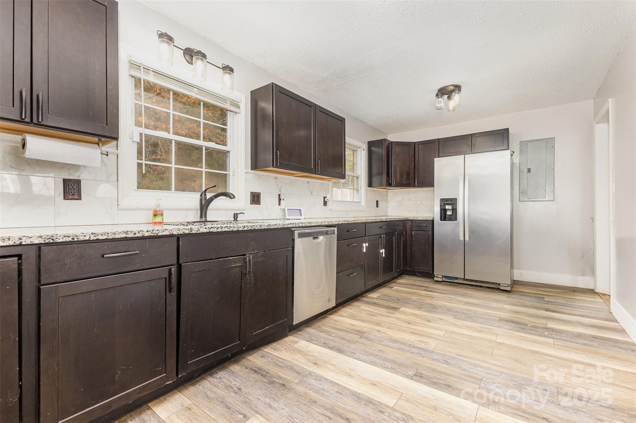 281 South Sutton Road Fort Mill, SC 29708 - Photo 8 of 21 a kitchen with granite countertop a sink stainless steel appliances and cabinets