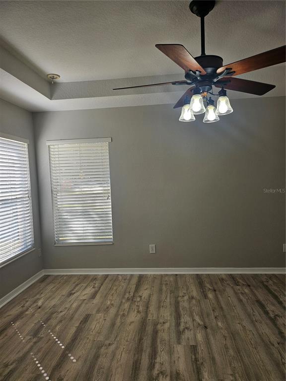 21332 Morning Mist Way Land O Lakes, FL 34637 - Photo 16 of 25 a view of an empty room with window and chandelier fan