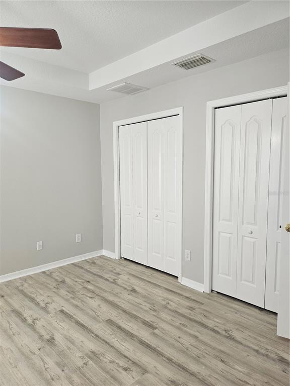21332 Morning Mist Way Land O Lakes, FL 34637 - Photo 17 of 25 a view of an empty room with wooden floor