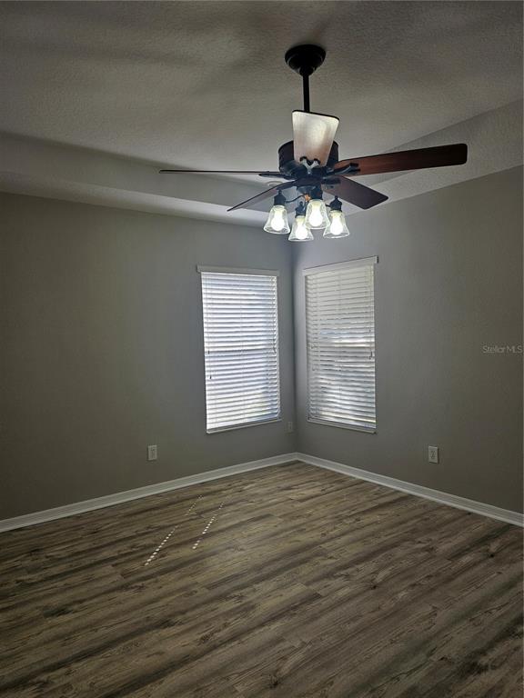 21332 Morning Mist Way Land O Lakes, FL 34637 - Photo 21 of 25 a view of an empty room with wooden floor and a window