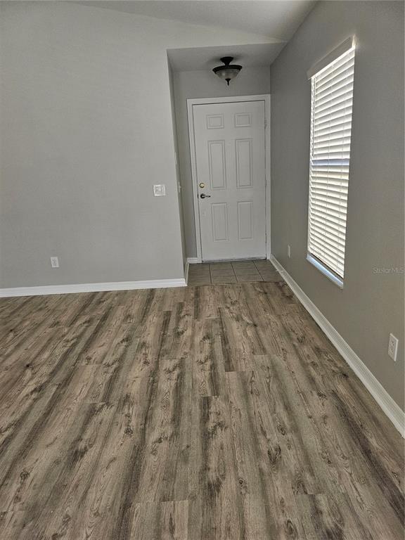 21332 Morning Mist Way Land O Lakes, FL 34637 - Photo 23 of 25 wooden floor in an empty room with a window