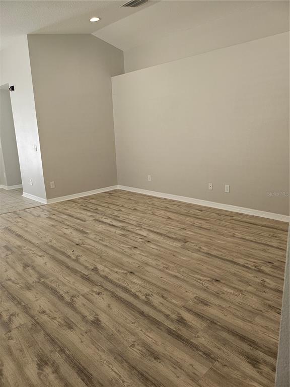 21332 Morning Mist Way Land O Lakes, FL 34637 - Photo 10 of 25 a view of an empty room with wooden floor and a window