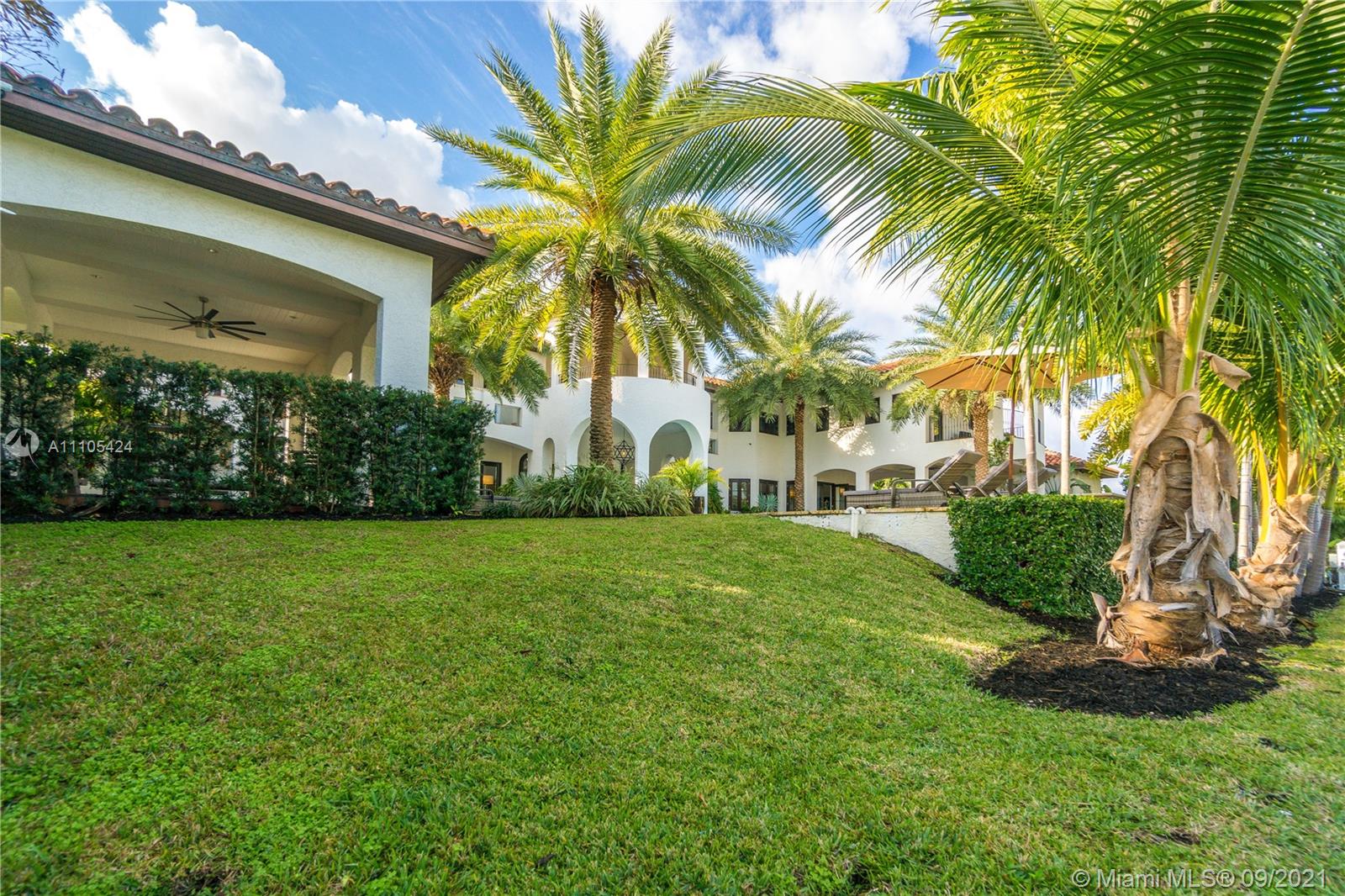 1201 Northeast 83rd Street Miami, FL 33138 - Photo 23 of 65 a view of a house with a yard and palm trees