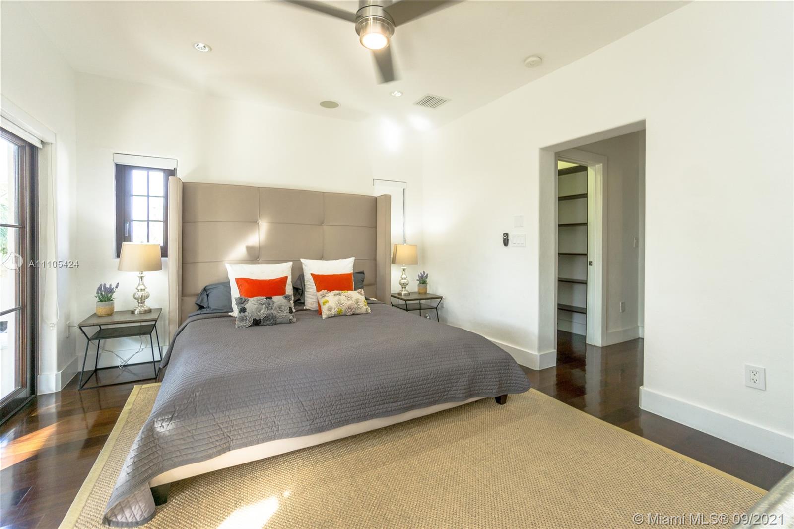 1201 Northeast 83rd Street Miami, FL 33138 - Photo 33 of 65 a bedroom with a bed and wooden floor