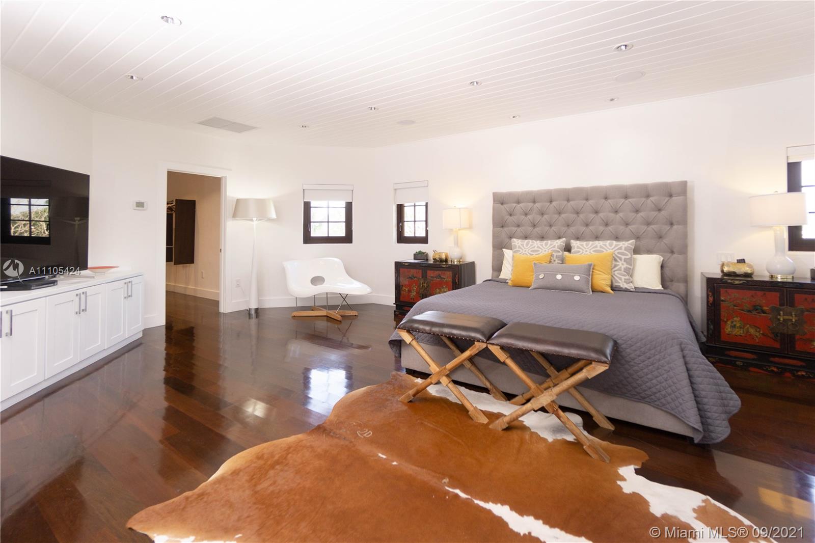 1201 Northeast 83rd Street Miami, FL 33138 - Photo 62 of 65 a bedroom with furniture and a flat screen tv