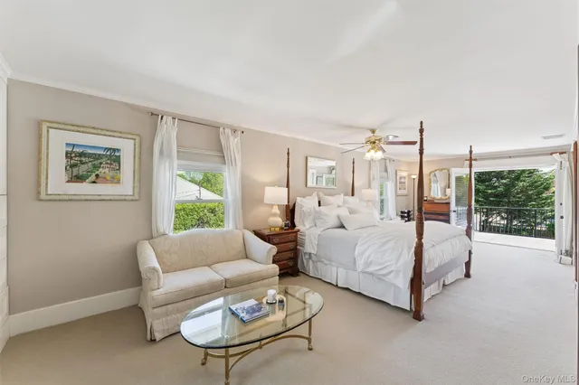 a bedroom with bed and glass window