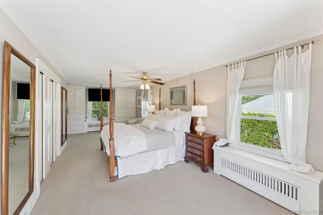 a spacious bedroom with a bed and a window