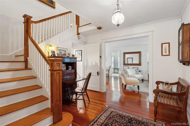 a view of a livingroom with furniture wooden floor and a chandelier