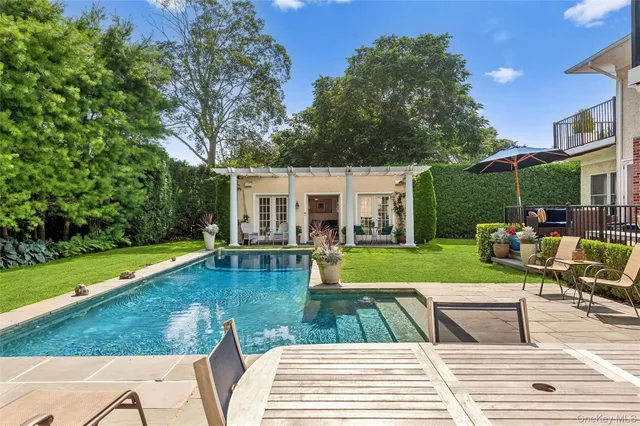 a view of a house with swimming pool and a yard