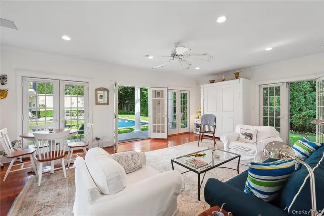 a living room with furniture and a floor to ceiling window