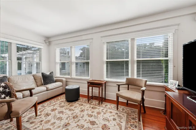 a living room with furniture and large windows