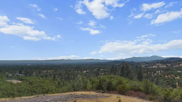 a view of a town with mountains in the background
