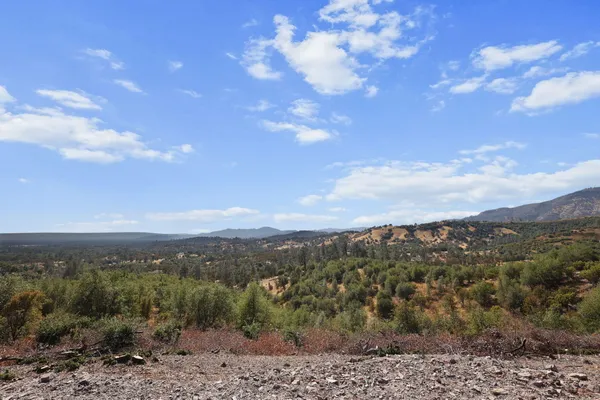 a view of a house with a mountain in the background