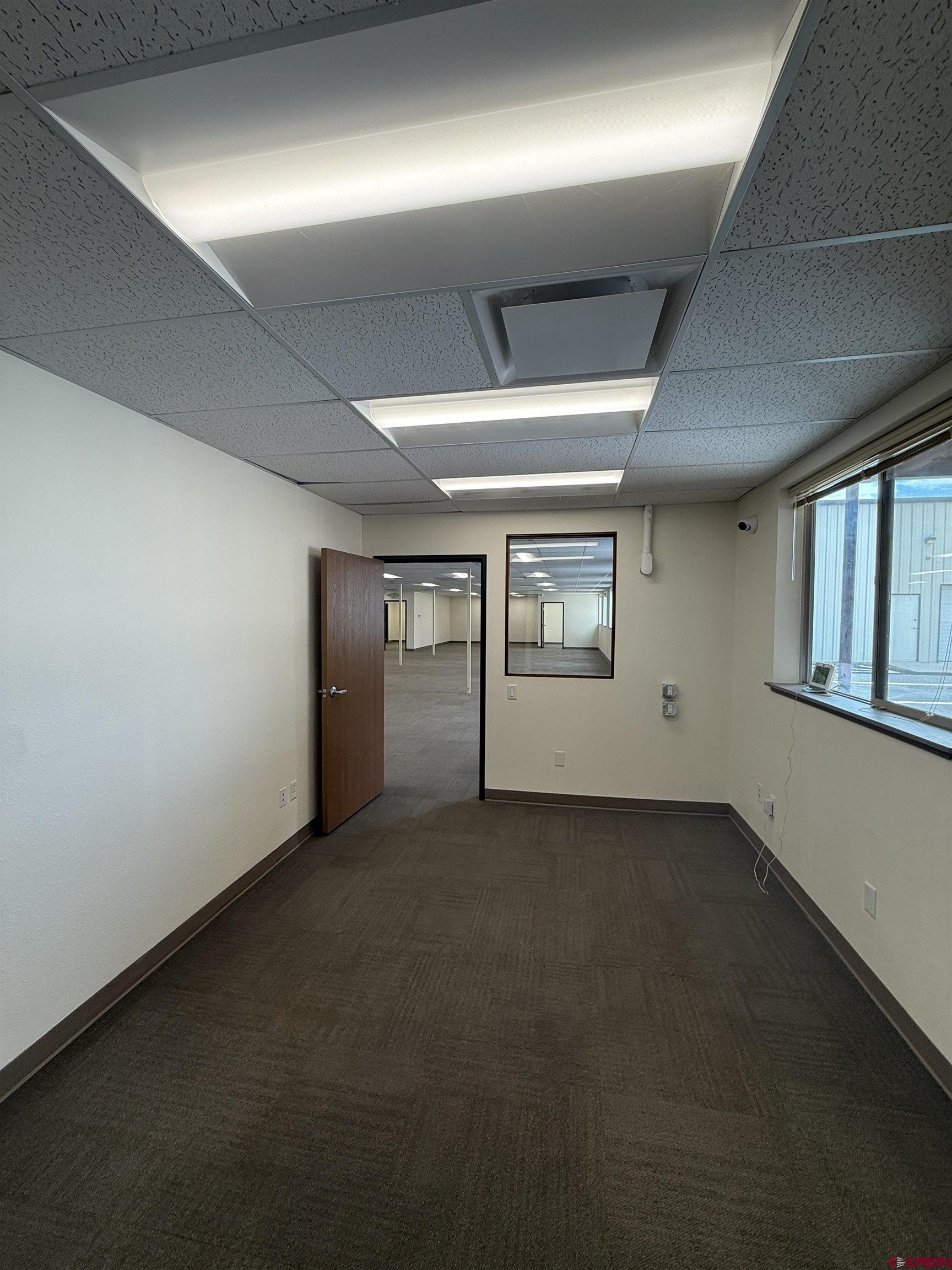675 Industrial Boulevard, Unit 103 AND GARAGE Delta, CO 81416 - Photo 14 of 31 an empty room with windows