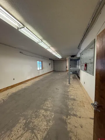 a view of a livingroom with furniture and a kitchen view