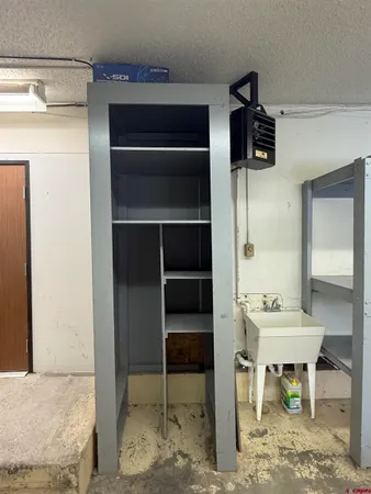 a view of a hallway that has a table and a chair in it