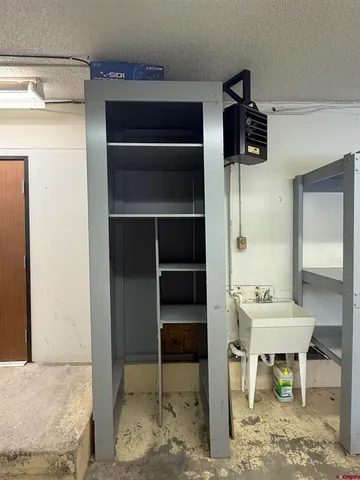 a view of a hallway that has a table and a chair in it