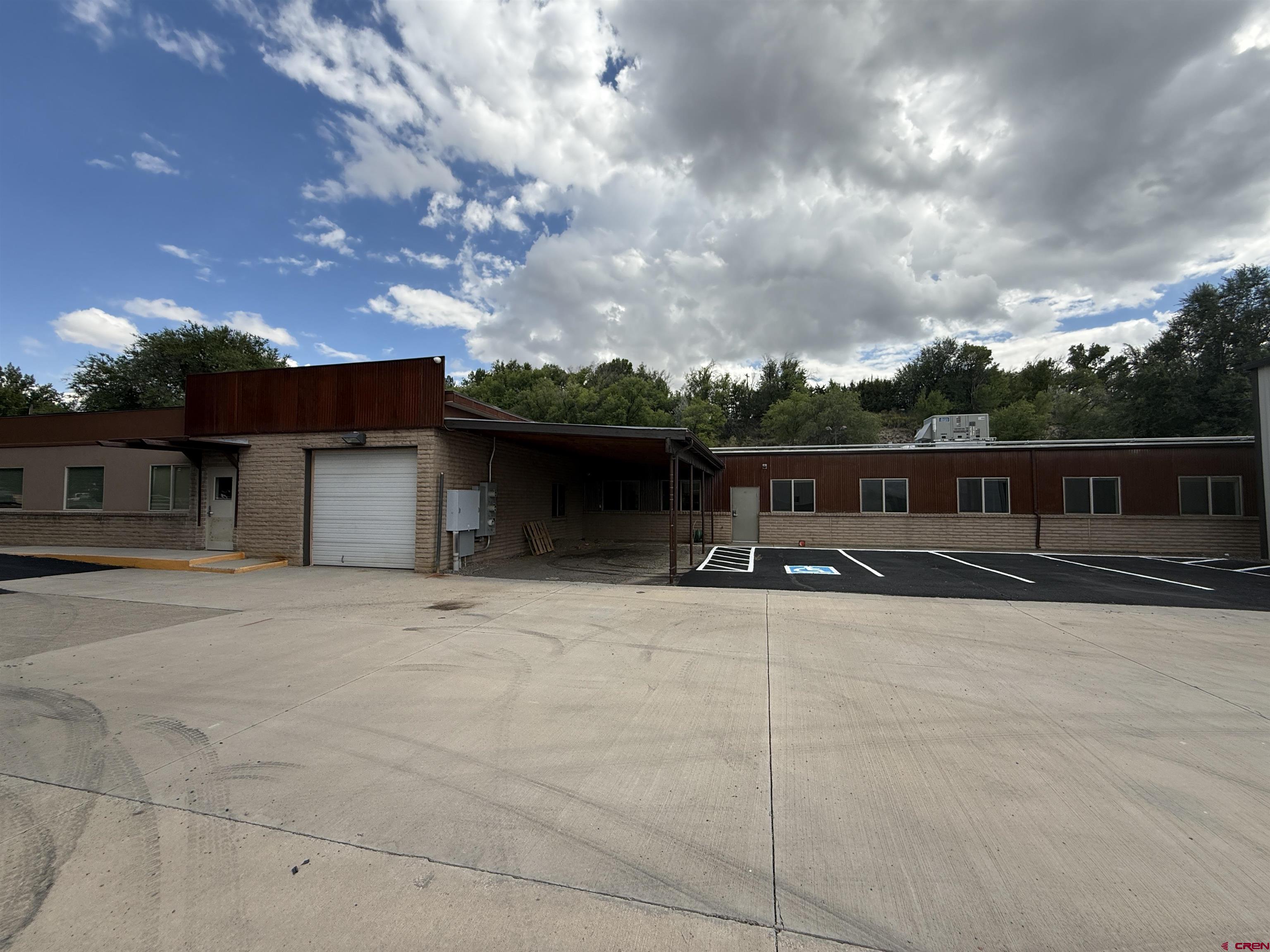 675 Industrial Boulevard, Unit 103 AND GARAGE Delta, CO 81416 - Photo 3 of 31 a front view of a house with yard