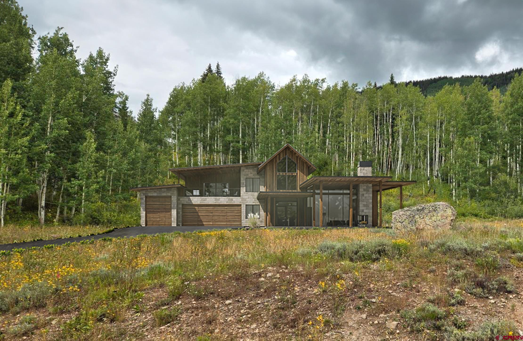 555 Meadow Drive Crested Butte, CO 81224 - Photo 2 of 24 a front view of a house with garden