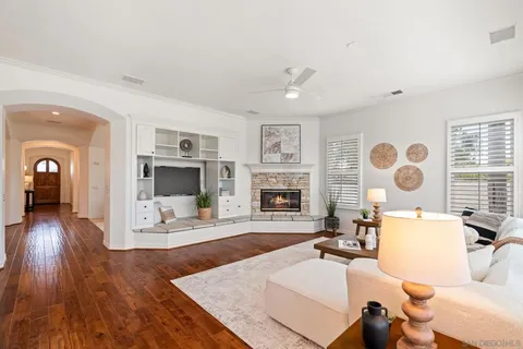 a living room with furniture large window and a fireplace