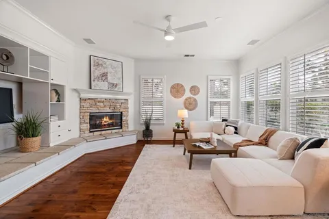 a kitchen with stainless steel appliances kitchen island granite countertop a dining table chairs stove refrigerator and microwave