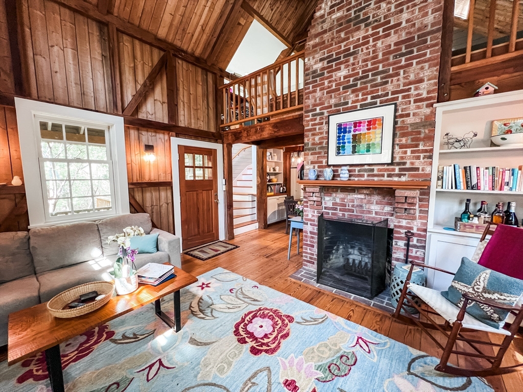 225 Lamberts Cove Road West Tisbury, MA 02568 - Photo 3 of 33 a living room with furniture a fireplace and a flat screen tv
