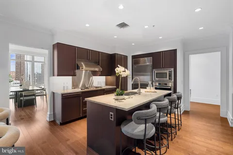 a kitchen with stainless steel appliances granite countertop a sink and a stove