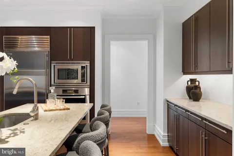 a kitchen with a refrigerator and a sink