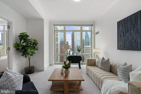 a view of a hallway with dining room and wooden floor