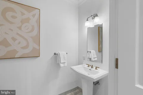 a bathroom with a granite countertop double vanity sink a mirror and a bathtub