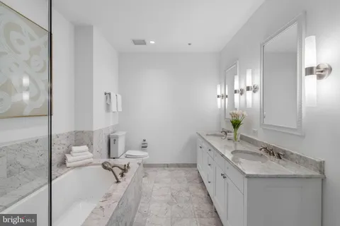 a bedroom with a bed couch and a window