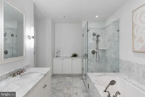 a bathroom with a double vanity sink and mirror